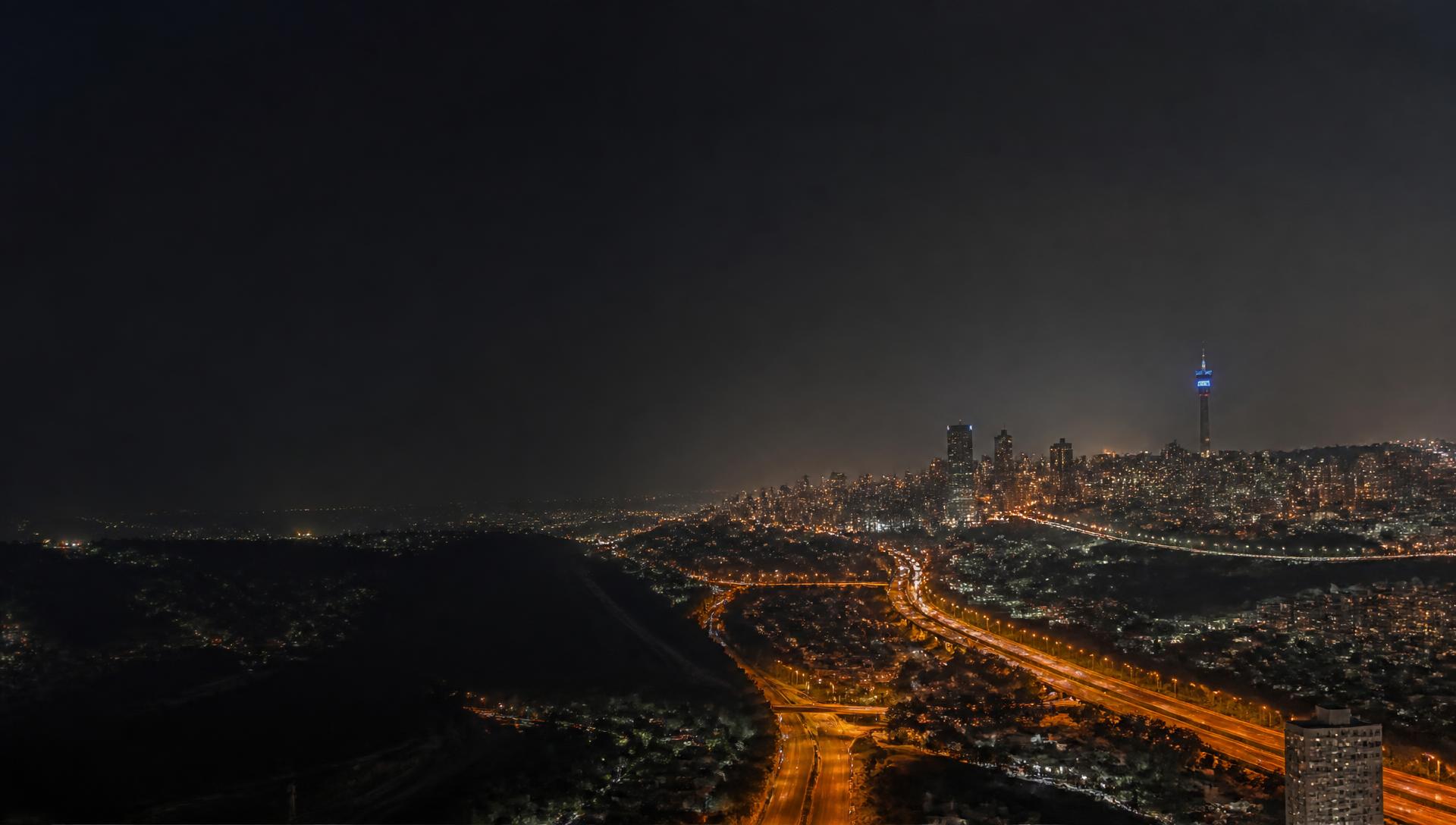 Johannesburg skyline at night with highway light trails